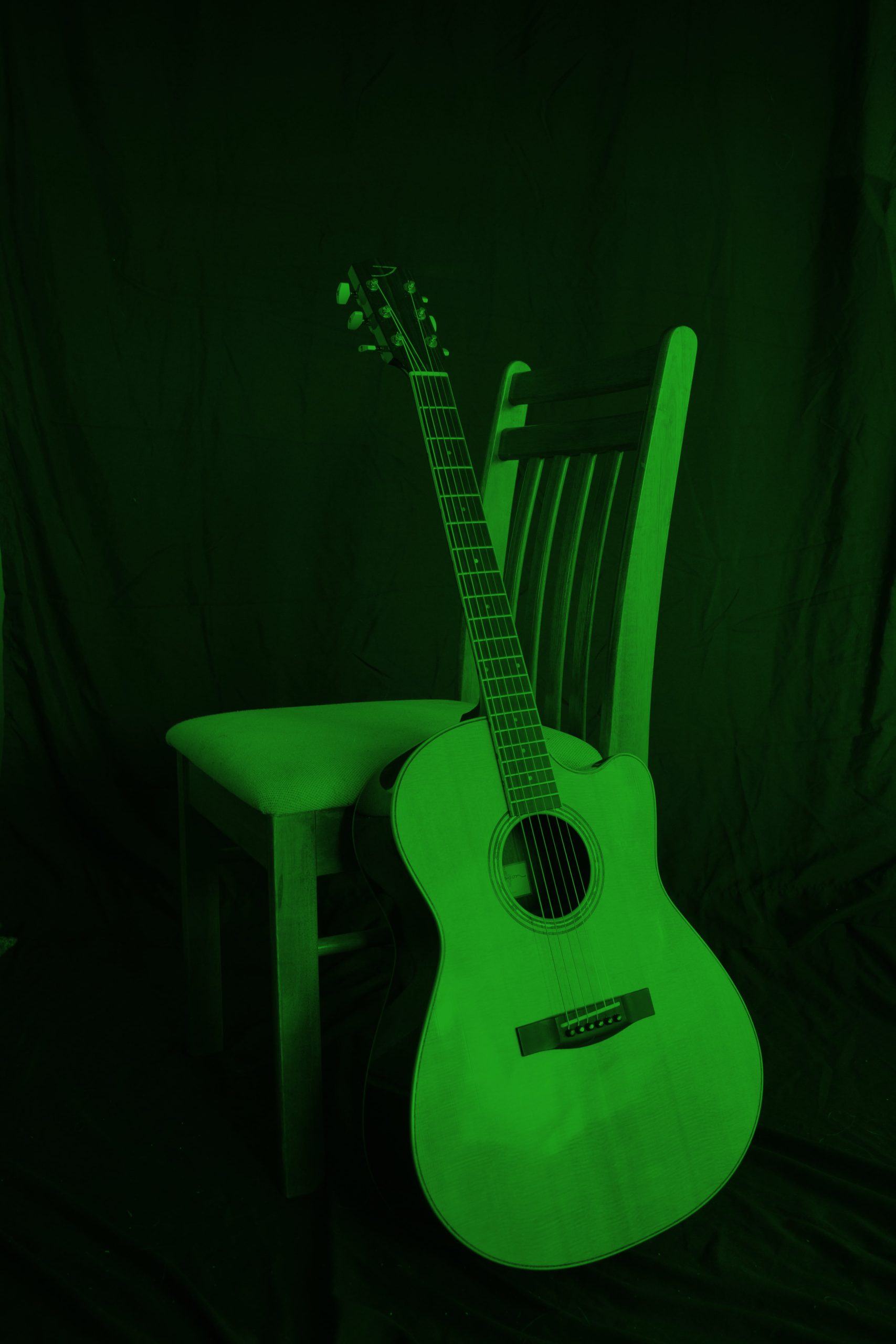 Green guitar and chair background.