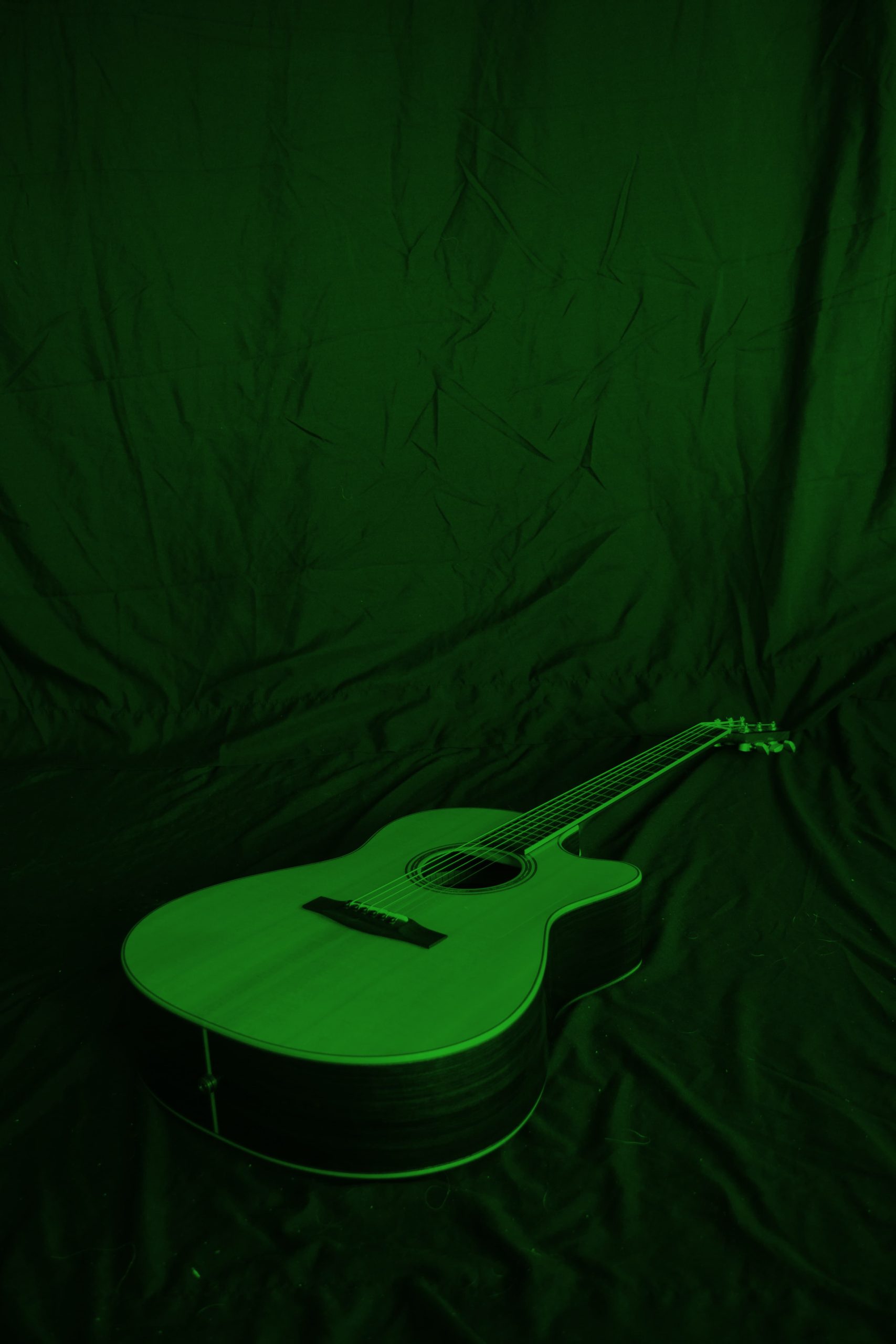 Green guitar on black background